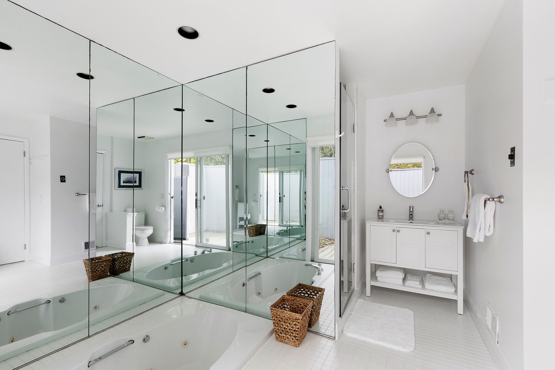 219 Town Line Road Wainscott, NY 11975 - Photo 10 of 19 a spacious bathroom with a tub shower and mirror