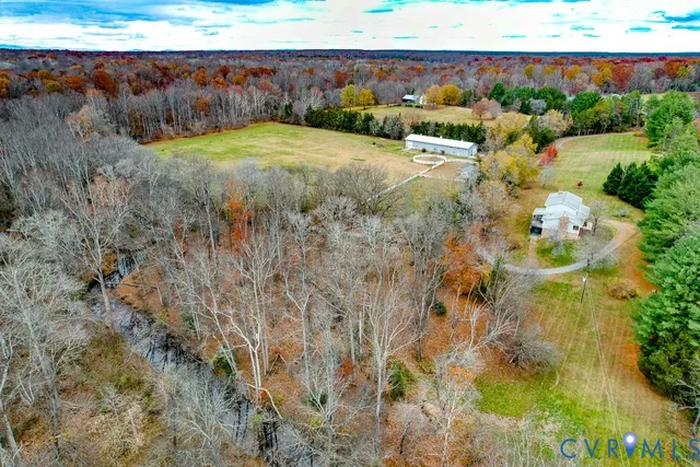 a view of a swimming pool with a yard and sitting area