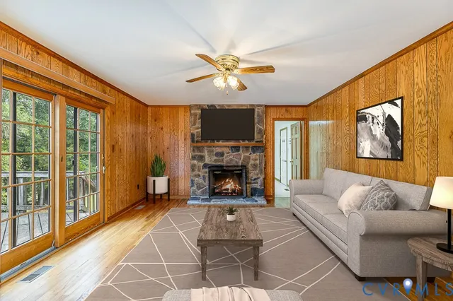 a bedroom with a large bed and a chandelier fan