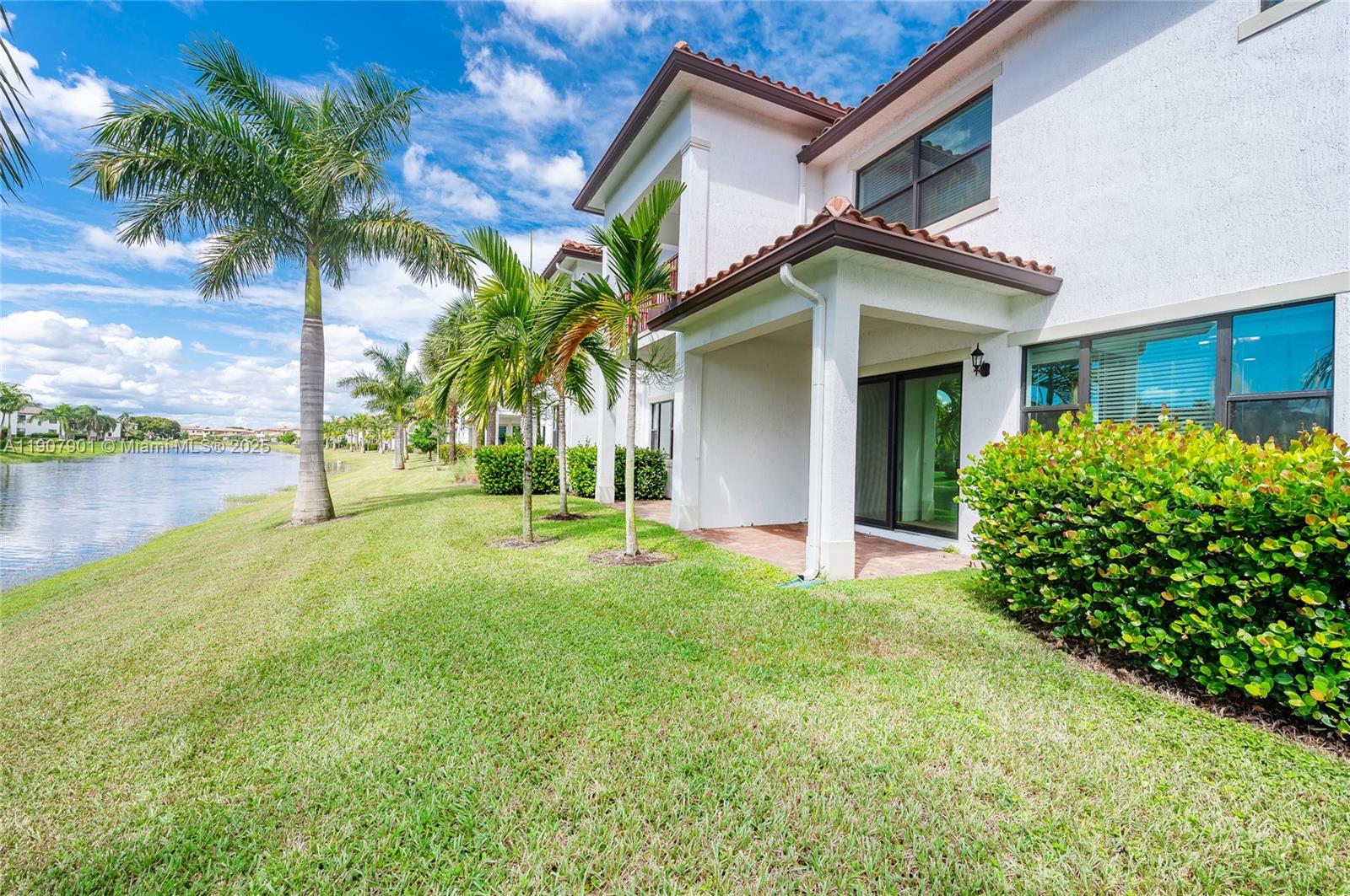 11670 Southwest 13th Lane, Unit 11670 Pembroke Pines, FL 33025 - Photo 11 of 38 a front view of a house with garden