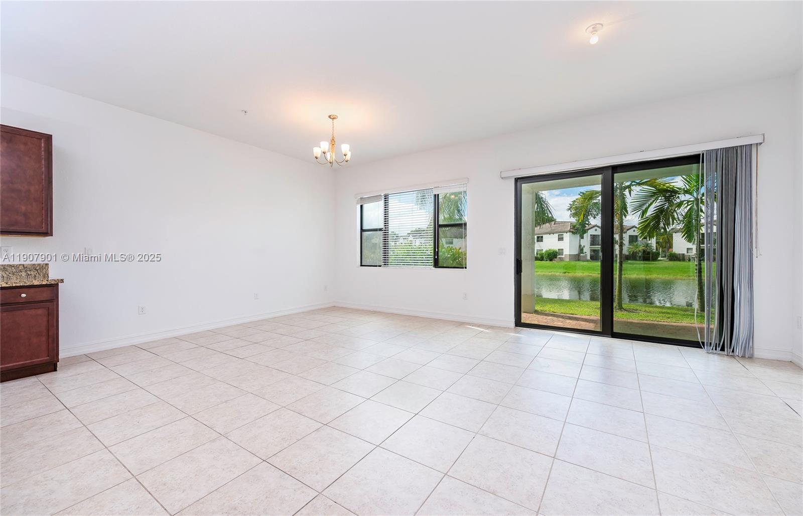 11670 Southwest 13th Lane, Unit 11670 Pembroke Pines, FL 33025 - Photo 12 of 38 a view of an empty room with a window