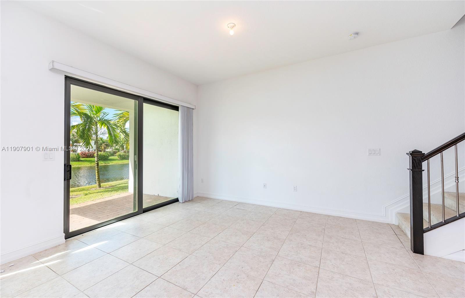 11670 Southwest 13th Lane, Unit 11670 Pembroke Pines, FL 33025 - Photo 14 of 38 a view of an empty room with a window