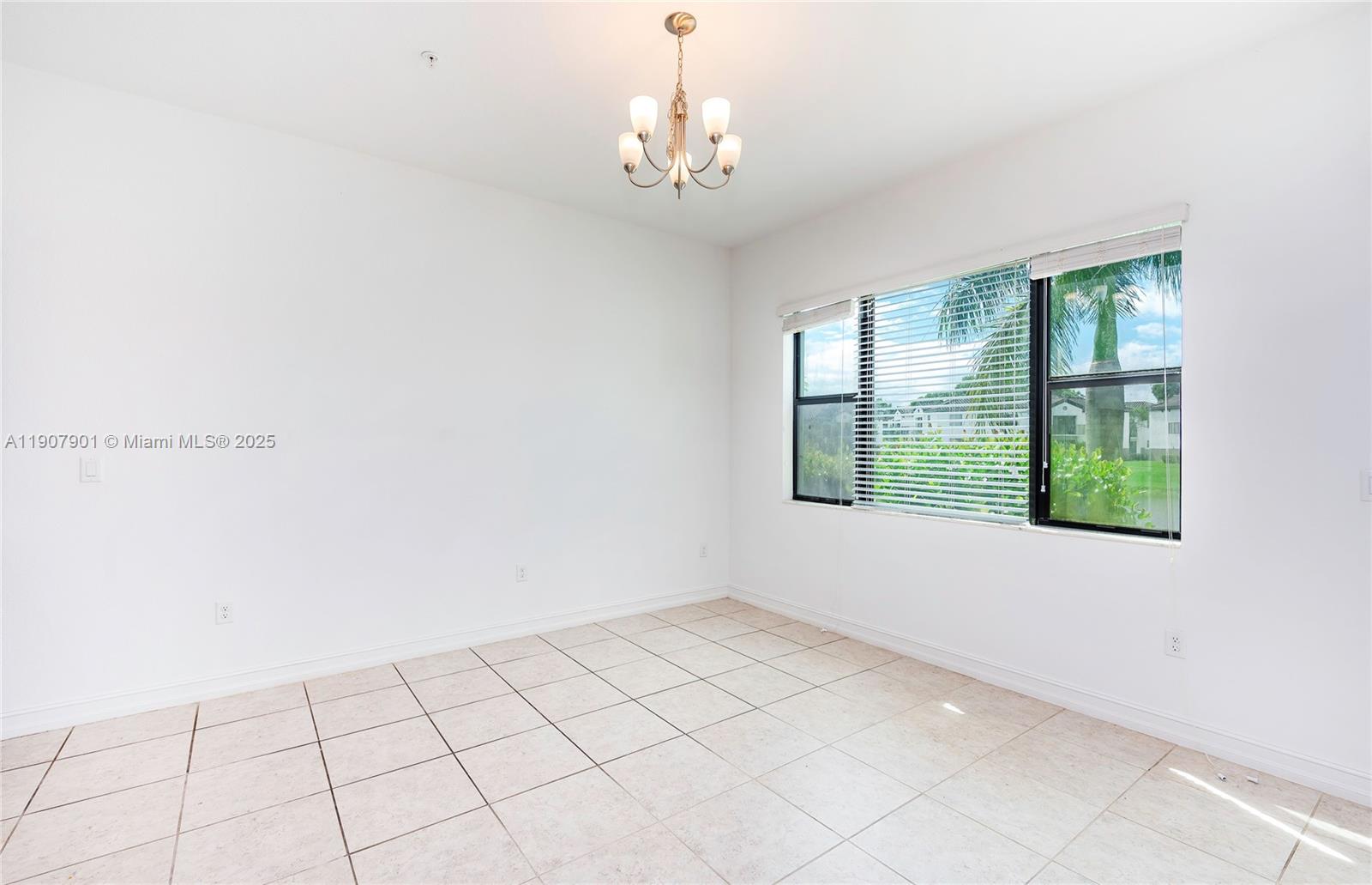 11670 Southwest 13th Lane, Unit 11670 Pembroke Pines, FL 33025 - Photo 15 of 38 a view of an empty room with a window