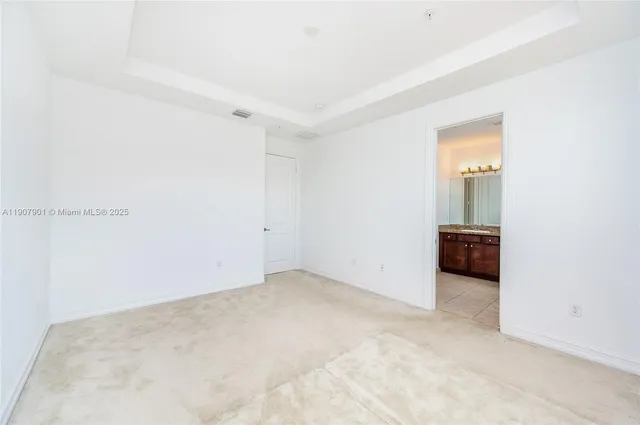 a bathroom with a granite countertop sink a mirror and a shower