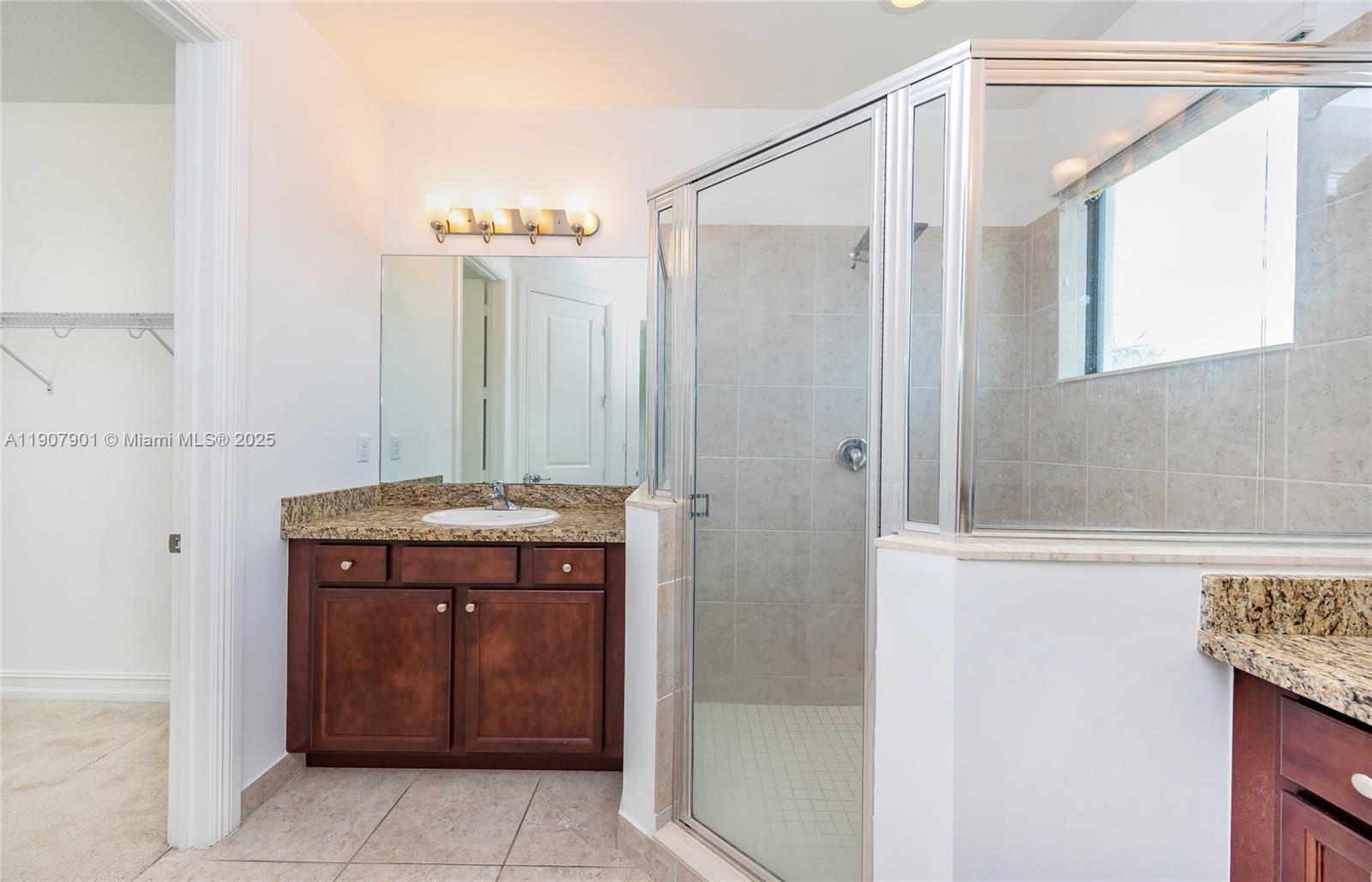 11670 Southwest 13th Lane, Unit 11670 Pembroke Pines, FL 33025 - Photo 25 of 38 a bathroom with a shower and a sink