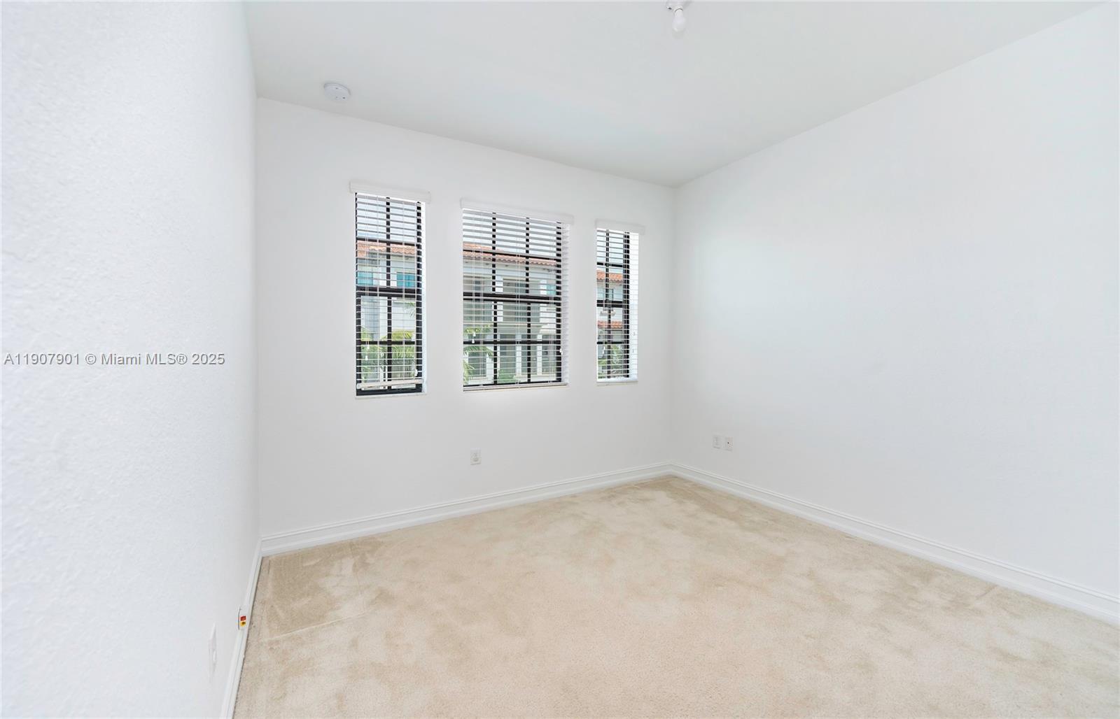 11670 Southwest 13th Lane, Unit 11670 Pembroke Pines, FL 33025 - Photo 27 of 38 an empty room with windows