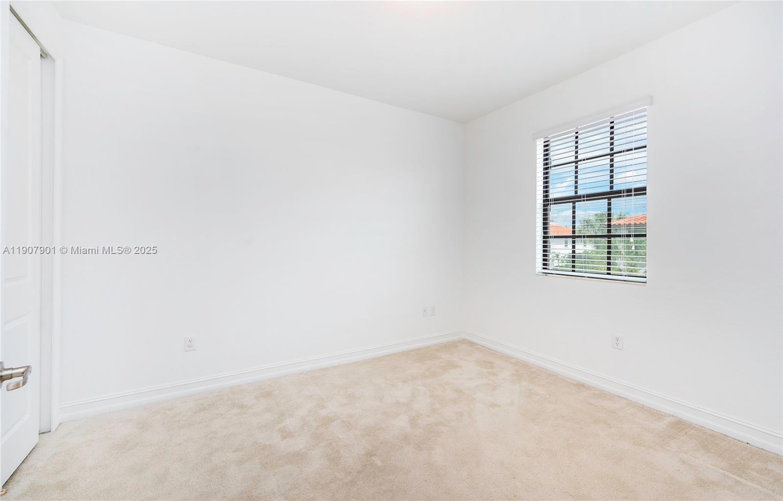11670 Southwest 13th Lane, Unit 11670 Pembroke Pines, FL 33025 - Photo 28 of 38 an empty room with a window