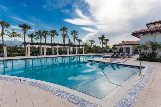 a view of swimming pool with a yard and plants