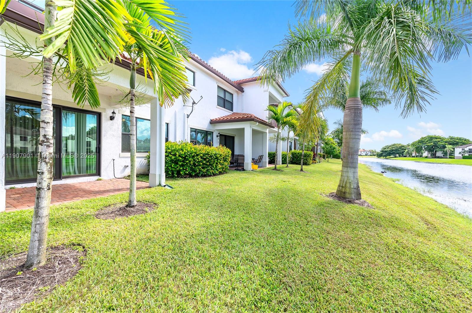 11670 Southwest 13th Lane, Unit 11670 Pembroke Pines, FL 33025 - Photo 4 of 38 a view of a house with swimming pool and a large tree