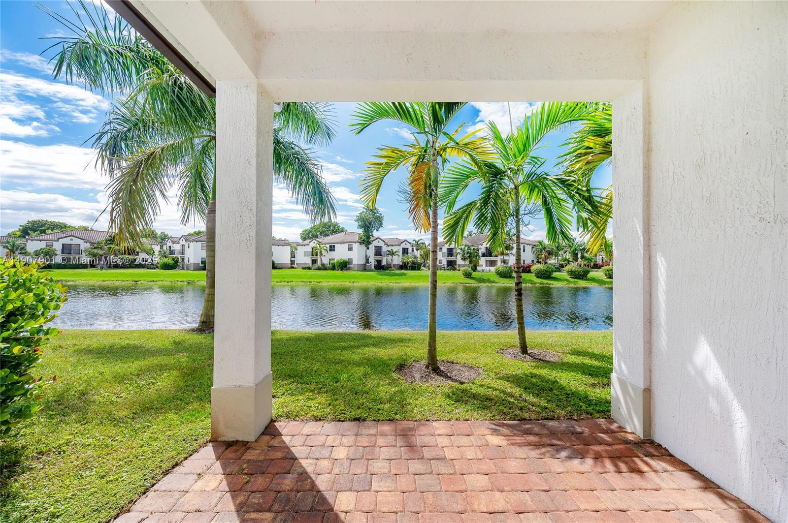 11670 Southwest 13th Lane, Unit 11670 Pembroke Pines, FL 33025 - Photo 8 of 38 a view of a swimming pool with a garden and plants