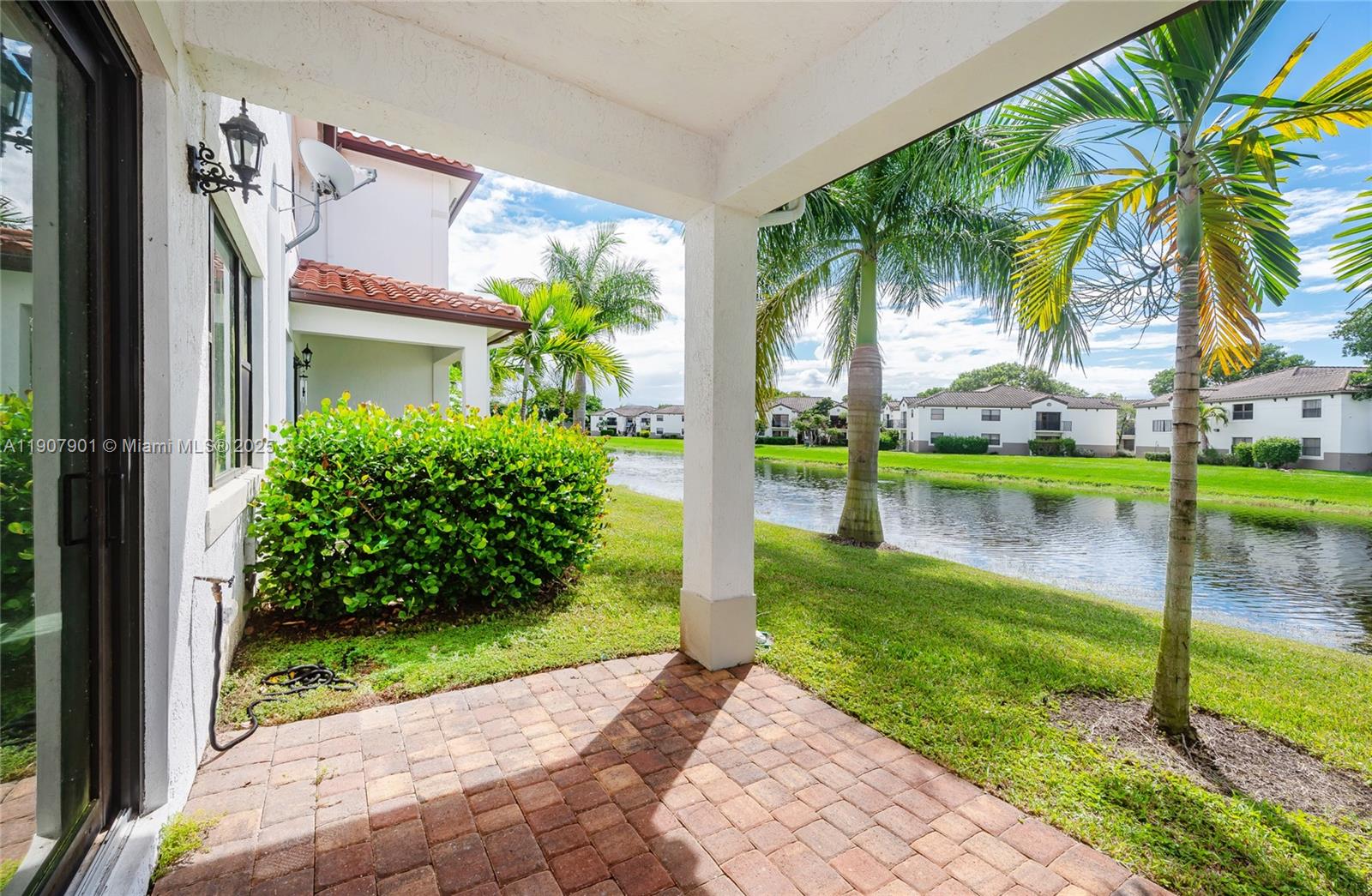 11670 Southwest 13th Lane, Unit 11670 Pembroke Pines, FL 33025 - Photo 9 of 38 a view of a garden from a patio