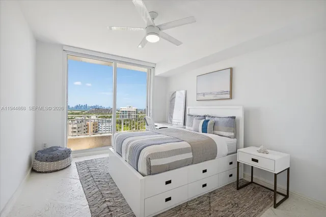 a spacious bedroom with a bed a couch and a window