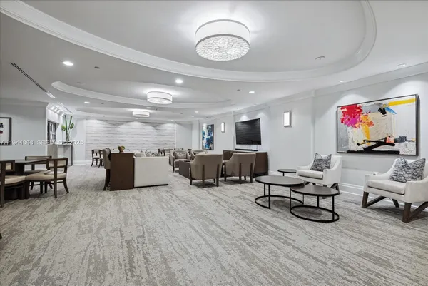 a living room with lots of furniture and kitchen view