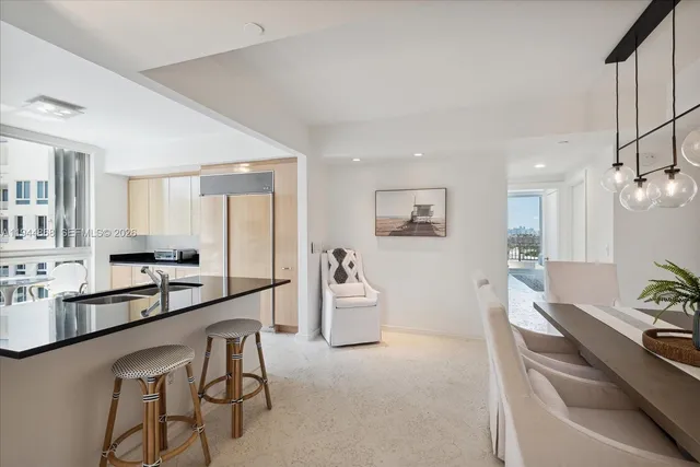 a large white kitchen with a large window
