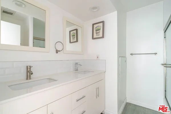 a roof deck with couches and potted plants
