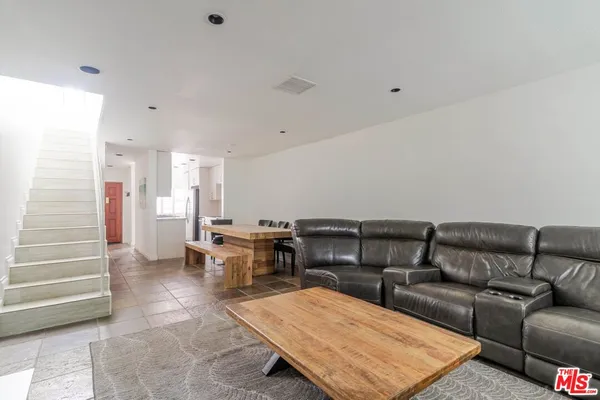 a living room with furniture a window and a table