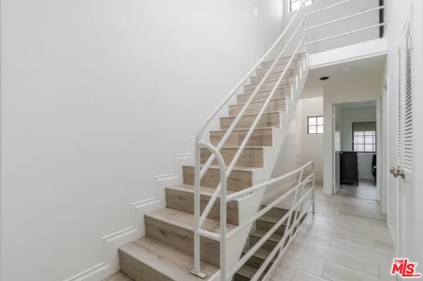 a kitchen with a sink stove top oven and cabinets