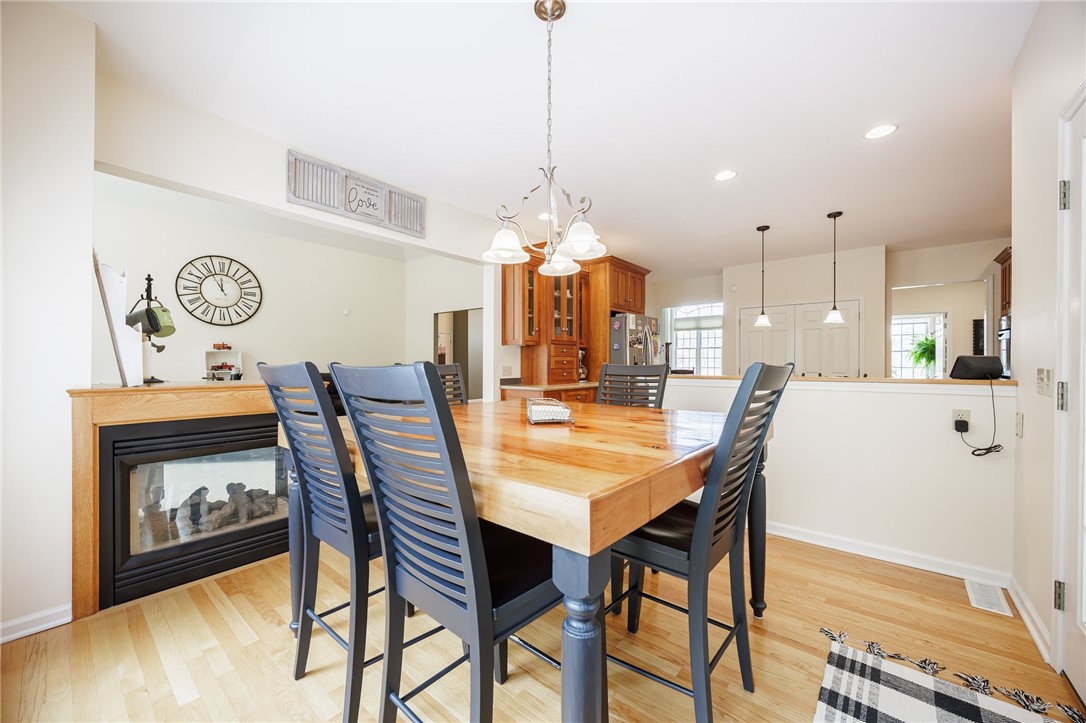 7638 Pine Tree Drive Victor, NY 14564 - Photo 16 of 50 Double sided fireplace can be enjoyed from the eat