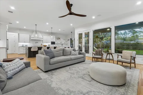 a open kitchen with stainless steel appliances granite countertop a lot of cabinets and wooden floor