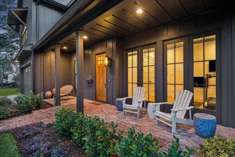 a building outdoor space with patio furniture and potted plants