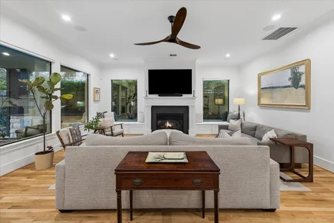 a living room with furniture fireplace and flat screen tv