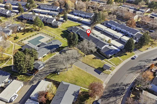 an aerial view of residential houses with outdoor space and ocean view