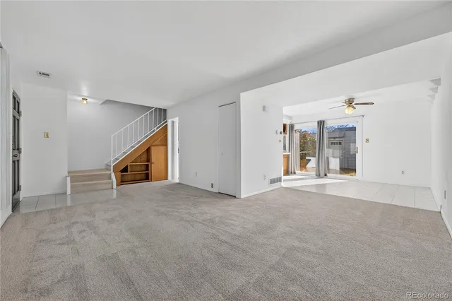 a view of an empty room with kitchen