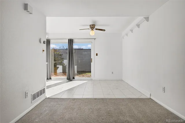 an empty room with windows and entrance