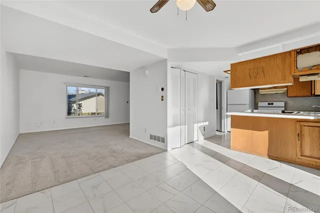 a large white kitchen with cabinets