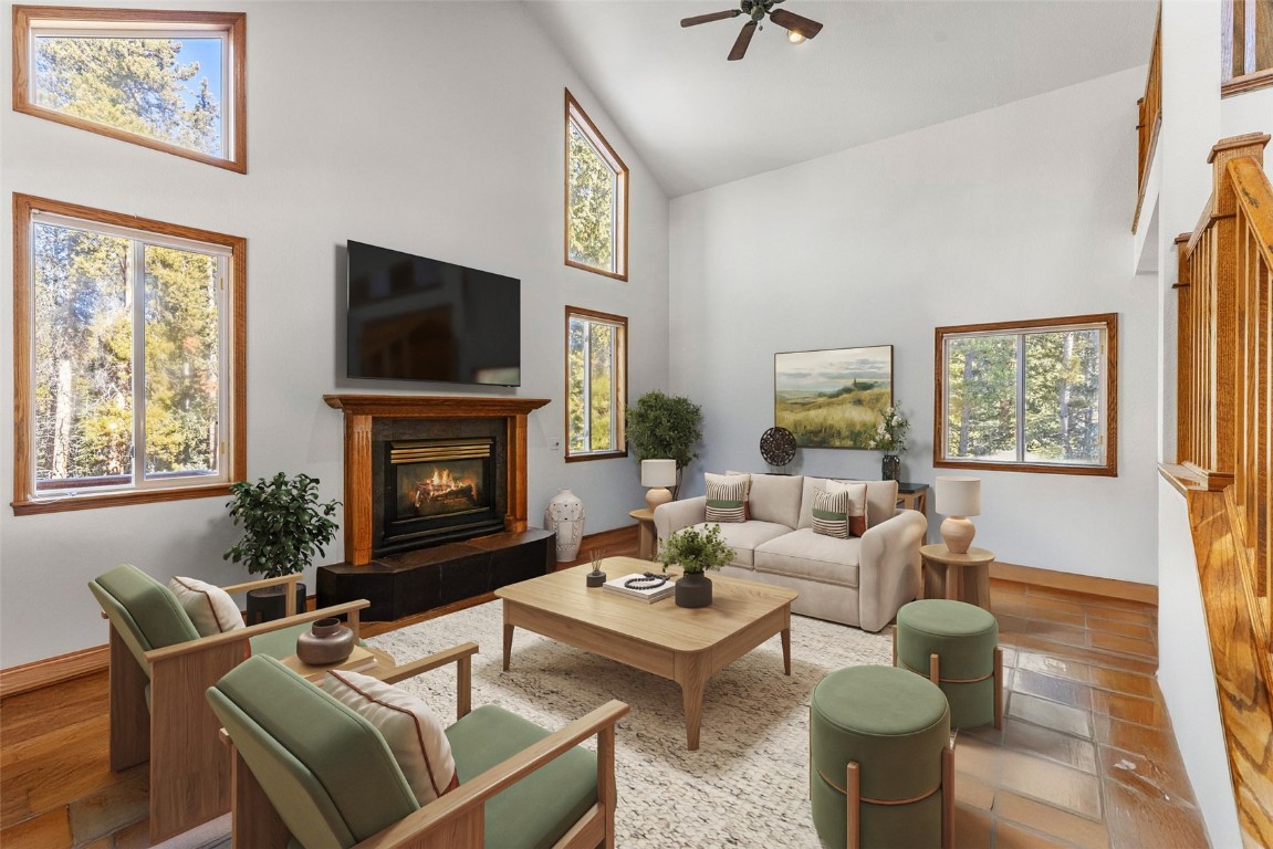 617 Moonstone Road Breckenridge, CO 80424 - Photo 11 of 21 a living room with furniture a flat screen tv and a fireplace