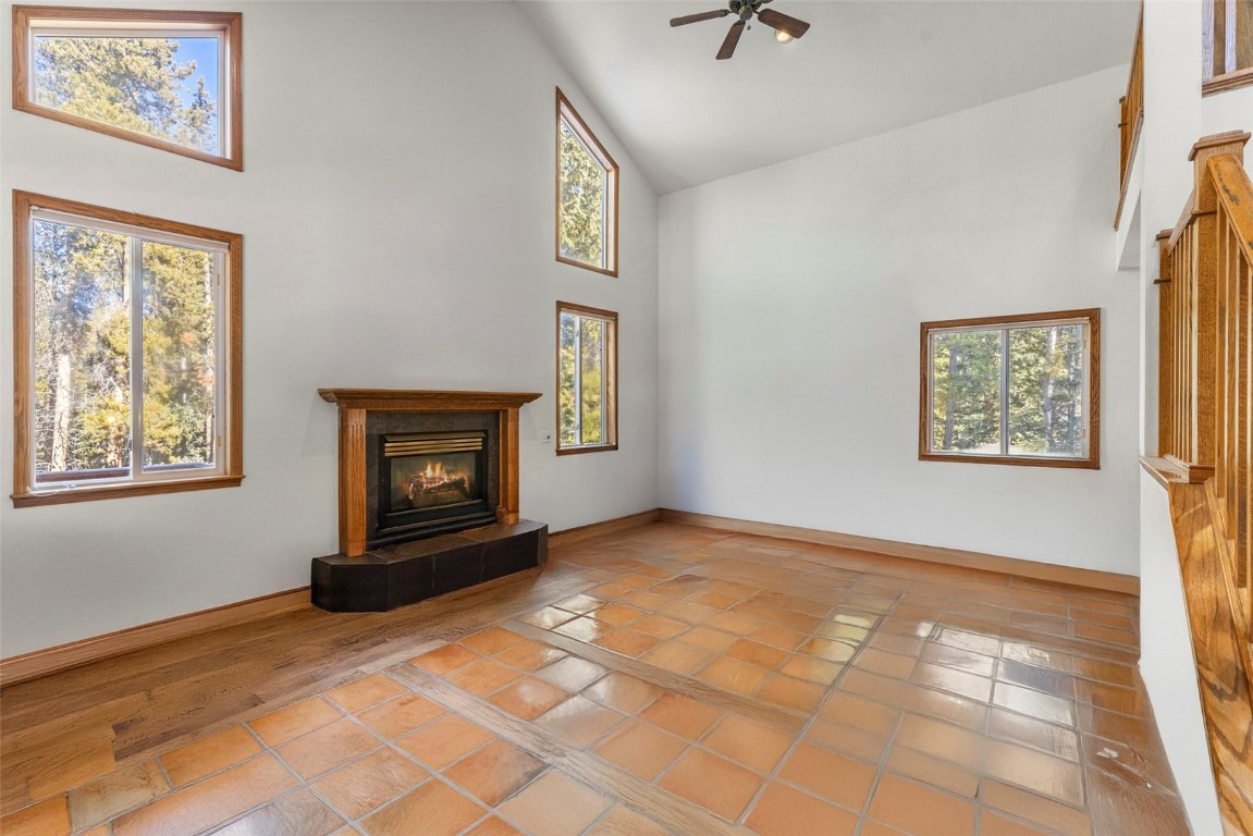617 Moonstone Road Breckenridge, CO 80424 - Photo 12 of 21 a view of an empty room with windows and a fireplace