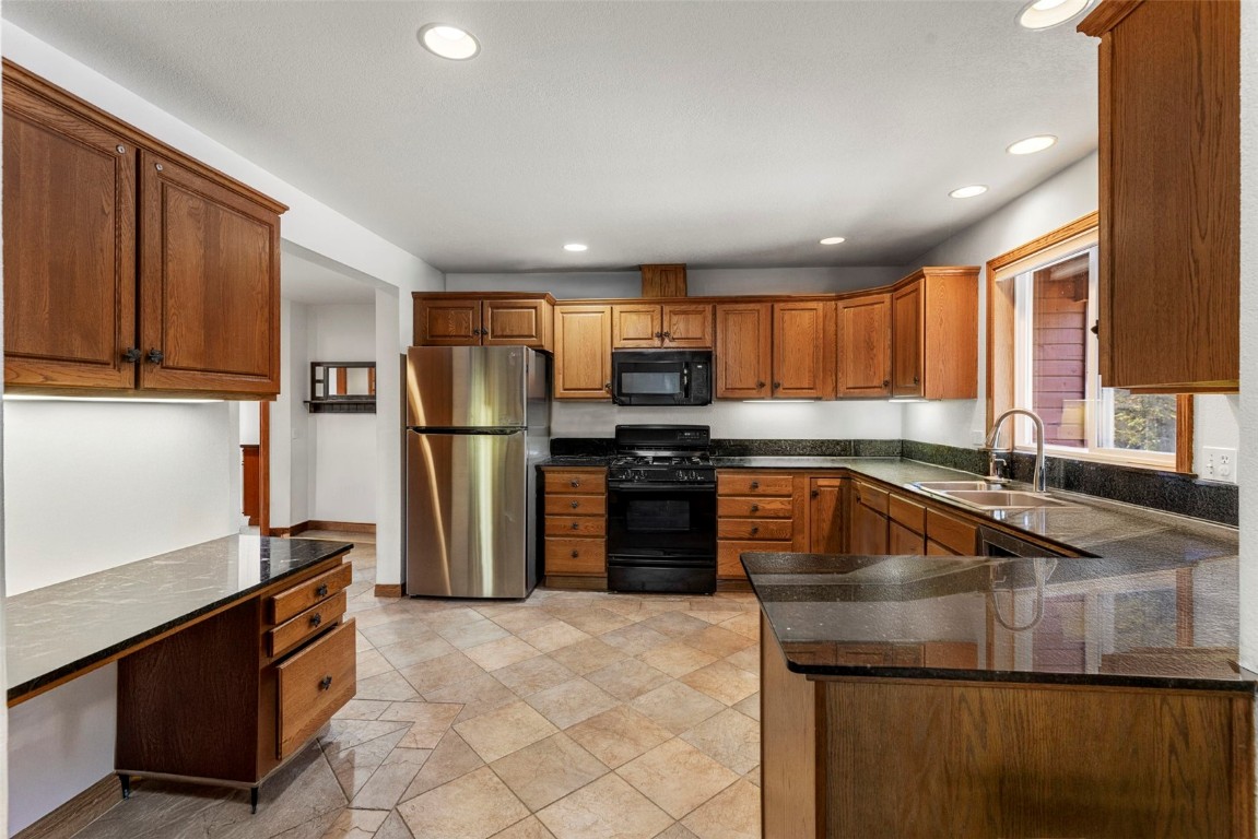 617 Moonstone Road Breckenridge, CO 80424 - Photo 16 of 21 a kitchen with a refrigerator sink and cabinets