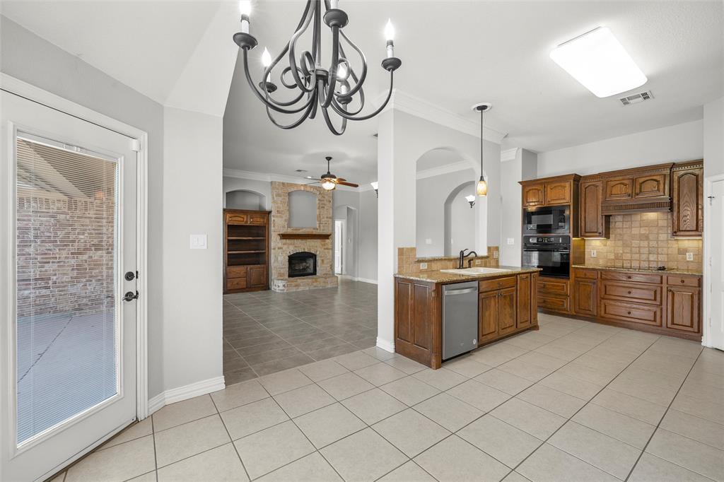 302 Canterbury Road Waco, TX 76712 - Photo 11 of 29 a large kitchen with stainless steel appliances a refrigerator and a stove top oven