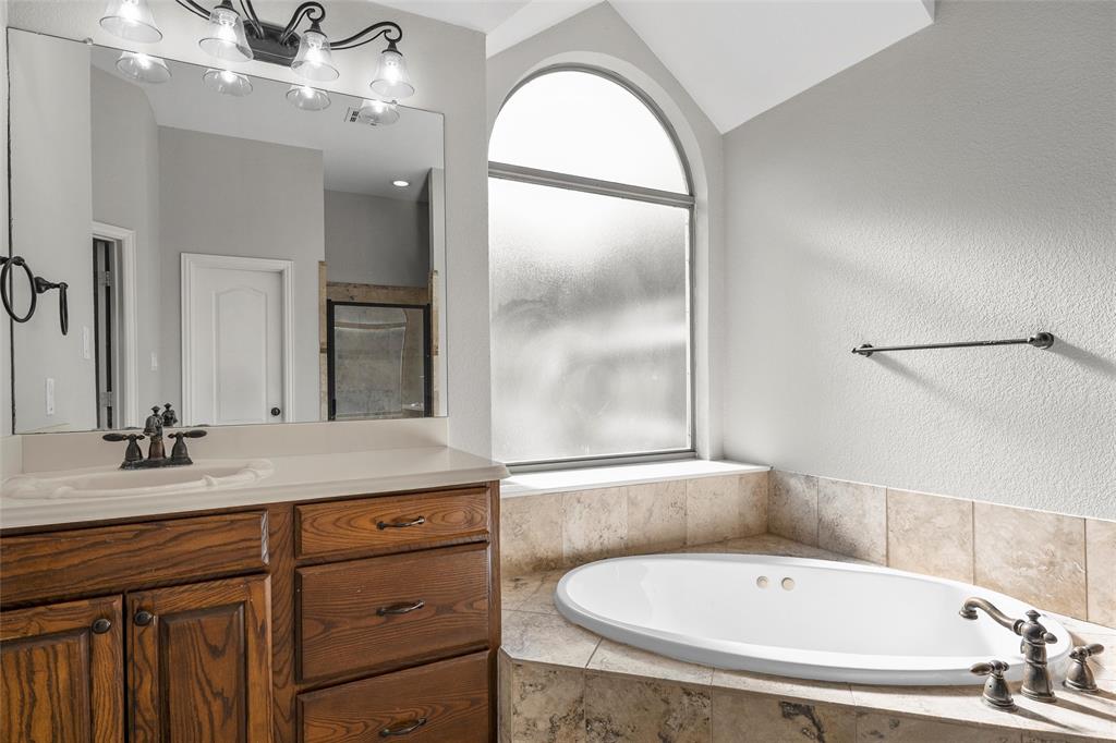 302 Canterbury Road Waco, TX 76712 - Photo 17 of 29 a bathroom with a tub sink and mirror