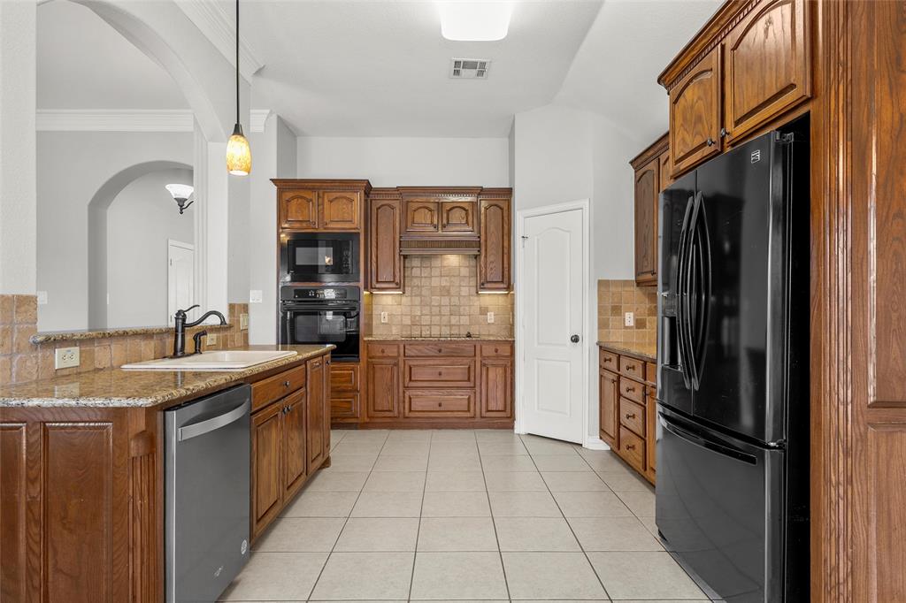 302 Canterbury Road Waco, TX 76712 - Photo 9 of 29 a kitchen with stainless steel appliances granite countertop a refrigerator and a sink