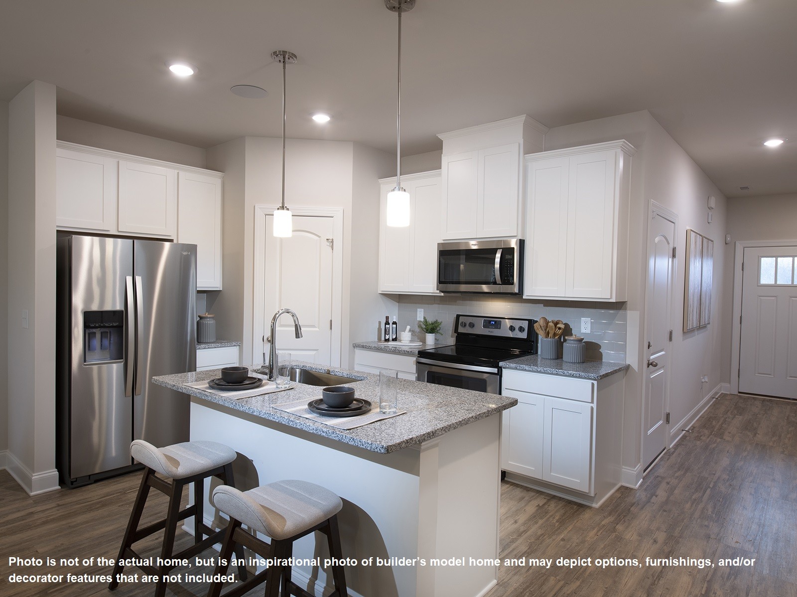 1329 Vilda Way Lebanon, TN 37087 - Photo 3 of 14 a kitchen with stainless steel appliances kitchen island granite countertop a sink refrigerator and microwave