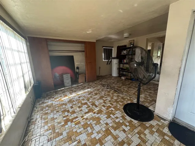 a bedroom with a bed and a chair