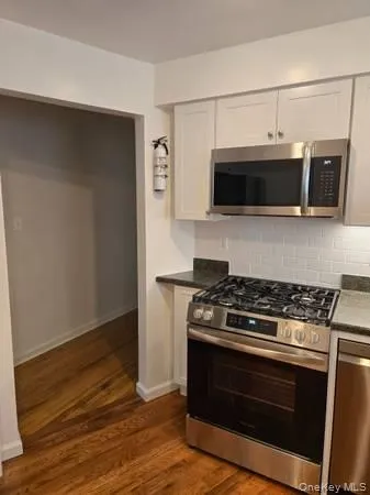 a kitchen with stainless steel appliances a stove and a microwave
