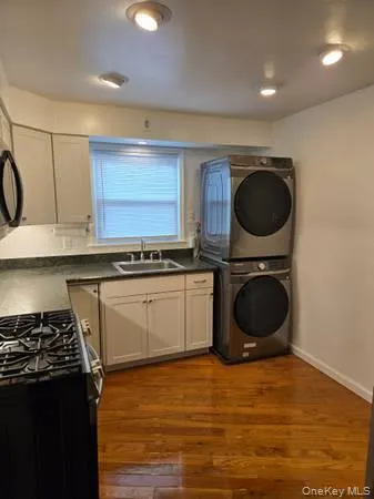 a kitchen with a stove a sink and a microwave