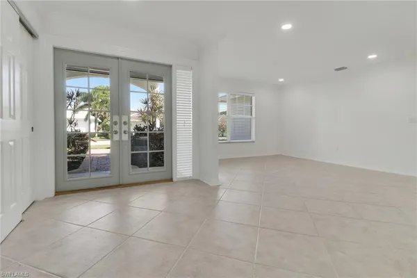 a view of an empty room with glass door