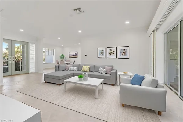 a living room with furniture and view of kitchen