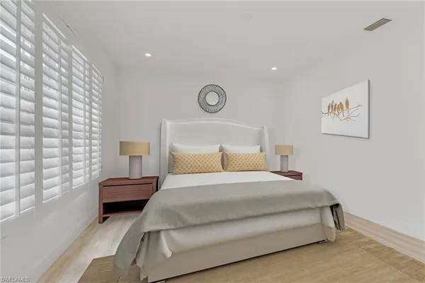 a bedroom with a bed and a lamp