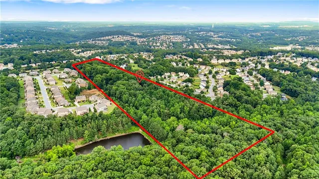 an aerial view of lake houses with an outdoor space and seating