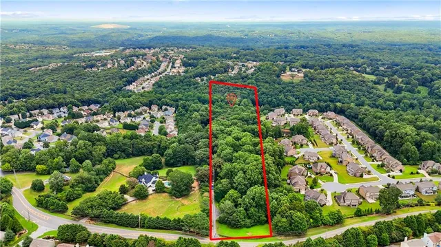 a backyard of a house with lots of green space and a fountain