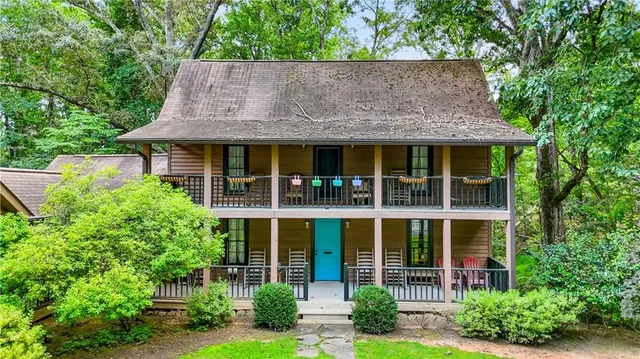 a view of a house with a patio and a yard