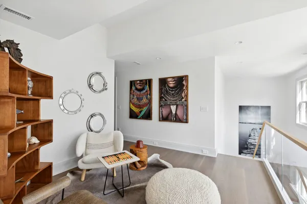a living room with furniture a rug and white walls