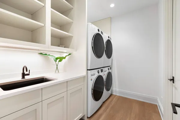 a utility room with sink dryer and washer