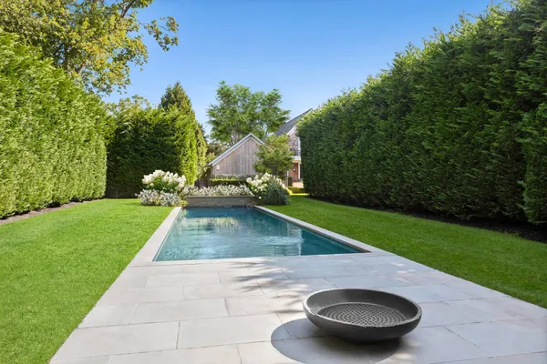 a view of a backyard with swimming pool