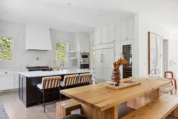 a kitchen with stainless steel appliances granite countertop a stove and white cabinets