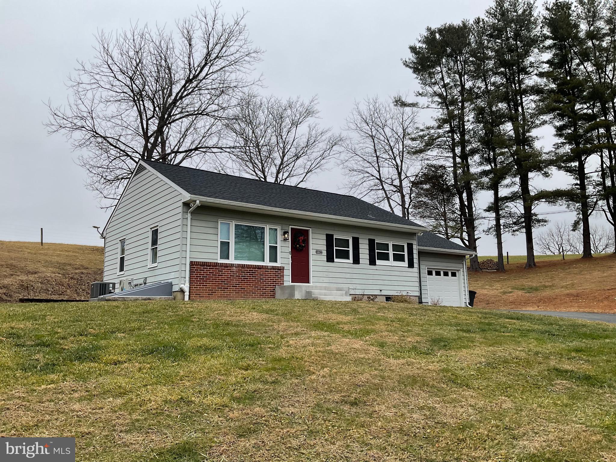 a house that has a tree in front of it